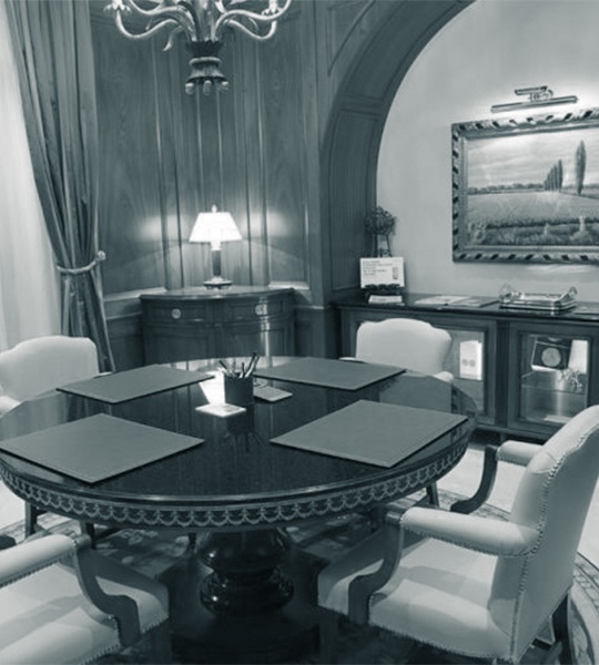 Rundes Besprechungszimmer mit Kronleuchter und Gemälden an der Wand in der Degussa Niederlassung in Genf